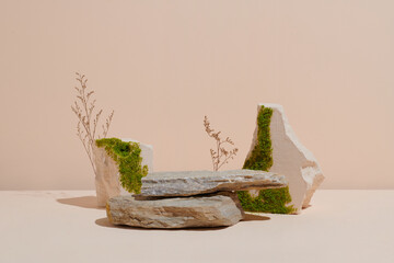 Natural stones with moss. Green, lush composition for product display.