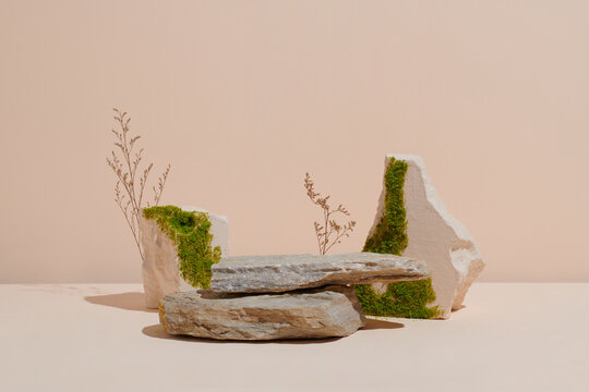 Natural stones with moss. Green, lush composition for product display.