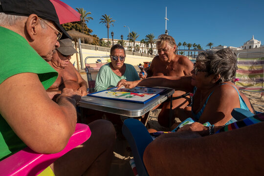A group of retirees playing a board game .