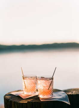 two drink by a lake in the evening 