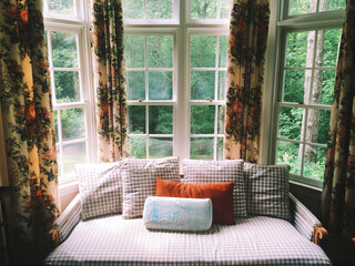 Bright window seat with floral curtains