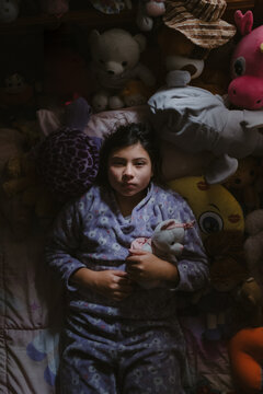cute young girl holding her teddy bear