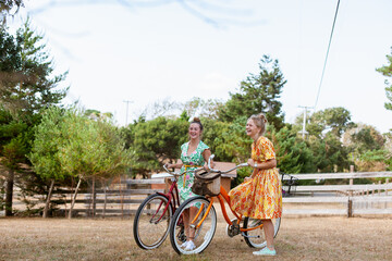 Two teen girls with vintage Bikes outdoor in summer