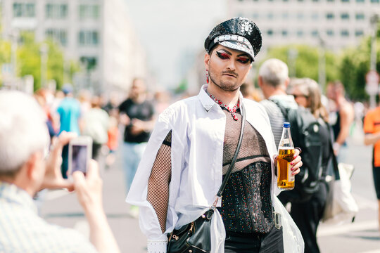 Voguing glam officer in Red heels marching at pride