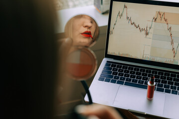 Woman at work applying red lipstick