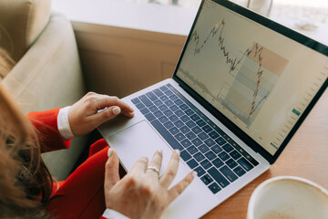 Anonymous woman analizing trading charts 