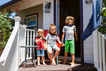 Children at porch with superhero capes