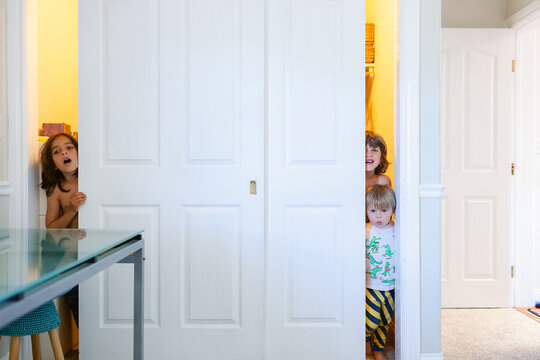 children playing hide and seek in closet