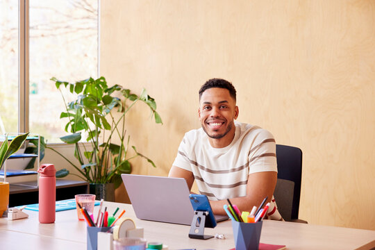 Cheerful man working on laptop