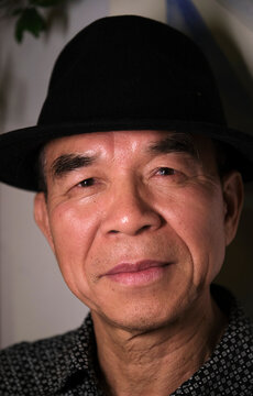 Closeup portrait of handsome and lovely old Asian man