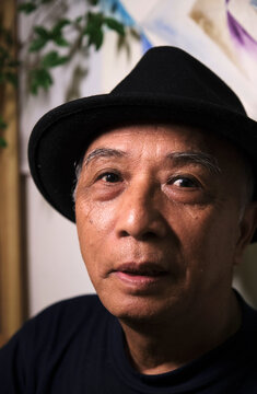 Closeup portrait of handsome and lovely old Asian man