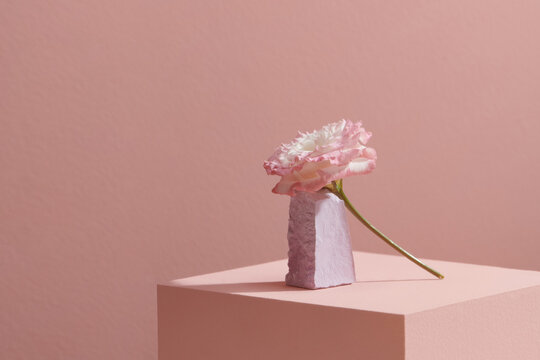 Geometric podium stand with pink flower