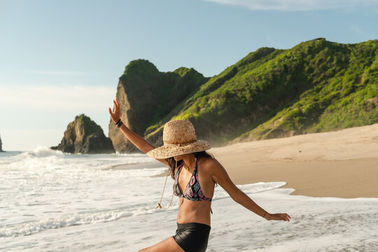 woman enjoying a sunny day at an exotic beach. travel woman 