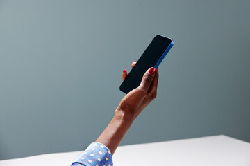 Cropped image of black woman with mobile phone in hand