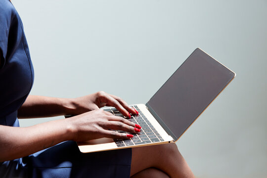 Cropped image of black female remote worker using computer