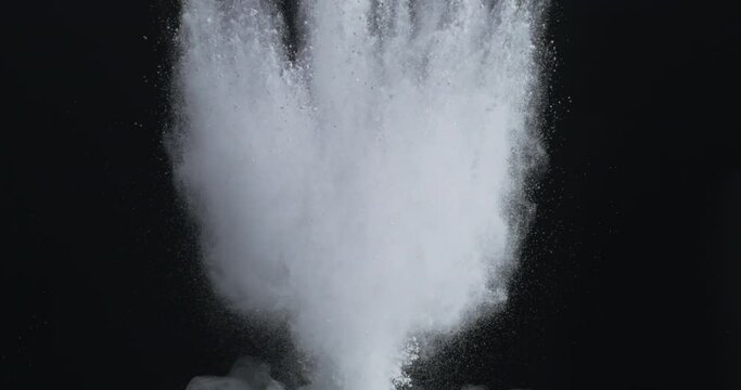 Slow Motion of The white dust powder exploding from the bottom up