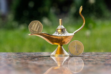 Aladdin's Magic Lamp, United Arab Emirates 50 fils oil rig coin and 1 Emirati dirham coin