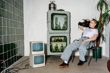 Calm woman with retro professional camera on shoulder