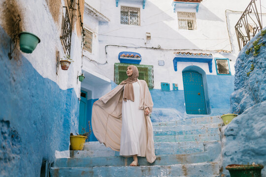 Elegant muslim woman walking on stairs