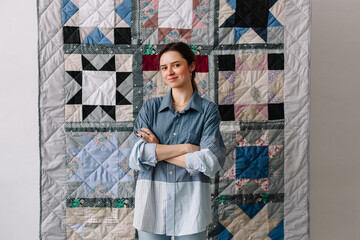 Upcycling designer presenting patchwork blanket