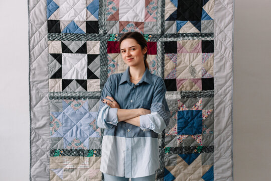 Upcycling designer presenting patchwork blanket