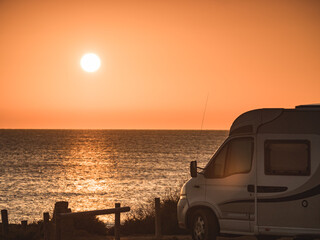 Fototapeta na wymiar Camper car on beach at sunrise