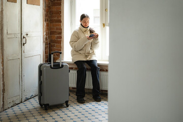 the girl is going to leave the house with a suitcase 
