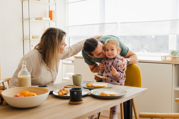 Loving Family Having Breakfast Together At Home