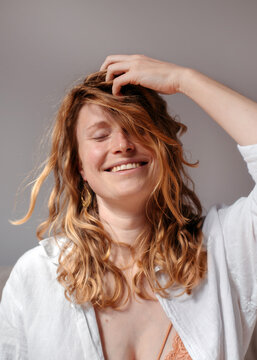 Happy blonde woman with disheveled hair