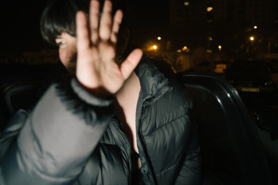 Woman getting out of a car avoiding the flash