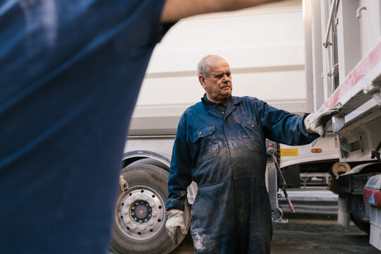 Senior mechanic checking truck before repair
