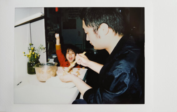Polaroid photo of Asian father and child making dumplings