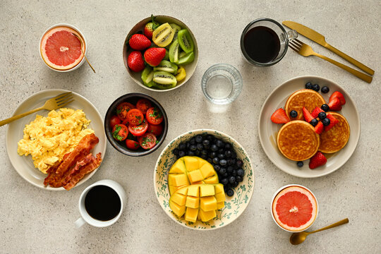 Served healthy breakfast. Eggs, pancakes, coffee. Overhead shot