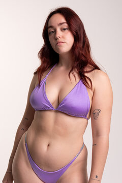 Studio portrait of curvy woman in bikini