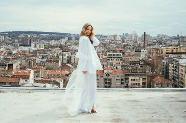 Beautiful Bride in White Suit Standing on Rooftop