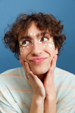Cheerful LGBT person touching cheeks
