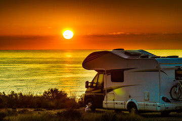 Caravan on sea at sunrise.