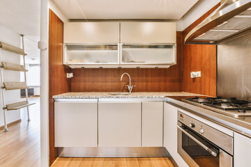 a kitchen with wood flooring and white appliances on the stove top in this photo is taken from the inside