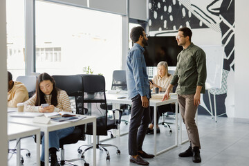Corporate employees discuss strategy busy workspace