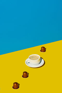Cup of coffee placed with capsules