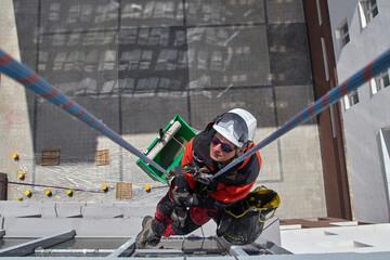 Rope access. Cleaning the windows of the skyscraper.