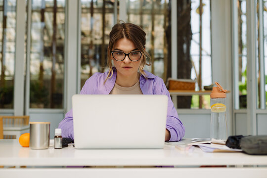 Concetrated woman working on netbook at home office