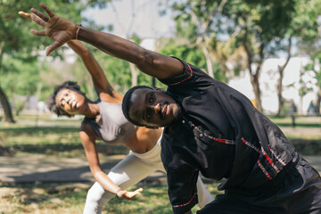Man and woman practicing stretching exercise.
