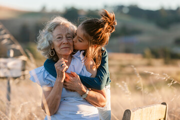Grandmother carrying her grandson through the field