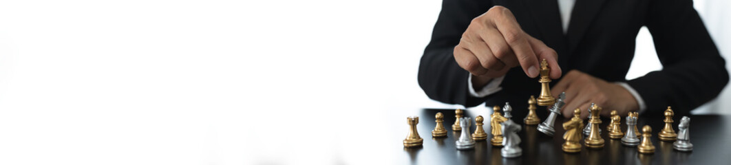 businessman concept, investor holding chess pieces playing chess board game in business competition and risk management plan business strategy leadership concept, copy space, panorama, banner