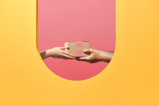 Woman hands accepting delivery of box from deliveryman, cropped