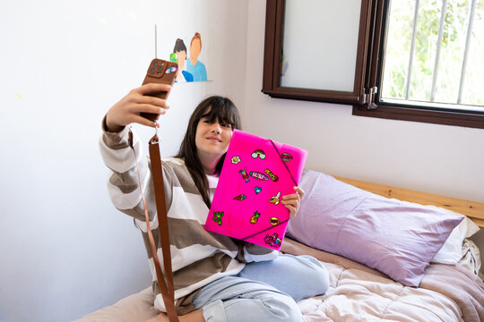 Teenager taking photos with customized folder