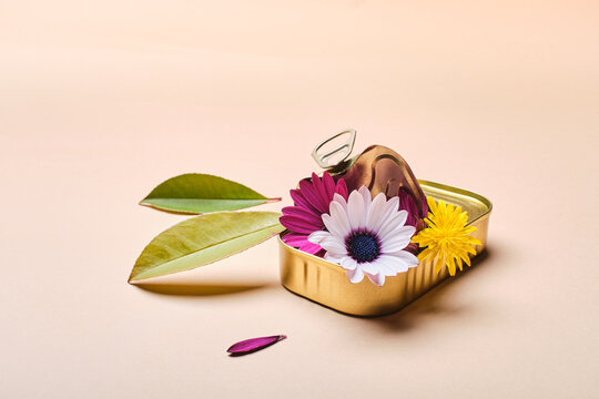 Tin can with flowers and leaves