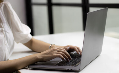Woman using laptop computer working at home. Technology and business concept.