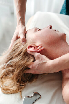Head massage procedure at spa.